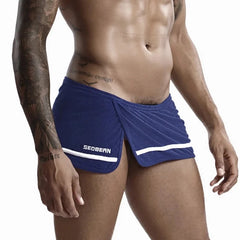 a hot gay man in dark blue Men's Running Shorts with Hidden Briefs - pridevoyageshop.com - gay men’s underwear and swimwear