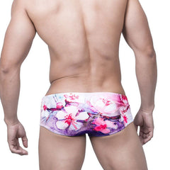 sexy gay man in Gay Swimwear | Pink Watercolor Swim Briefs- pridevoyageshop.com - gay men’s underwear and swimwear