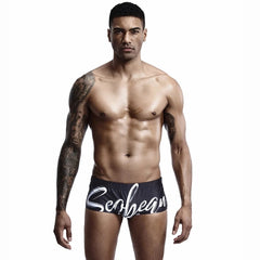 a hot gay man in black Alphabet Splash Square Cut Swim Trunks - pridevoyageshop.com - gay men’s underwear and swimwear