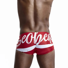 a hot gay man in red Alphabet Splash Square Cut Swim Trunks - pridevoyageshop.com - gay men’s underwear and swimwear