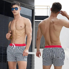a hot gay man in Red + White Desmiit Vertical Striped Board Shorts - pridevoyageshop.com - gay men’s underwear and swimwear