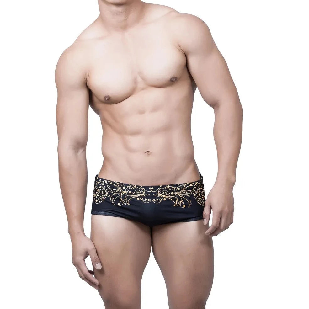 a hot gay man in Gold Fleur de Lis Square Cut Swim Trunks - pridevoyageshop.com - gay men’s underwear and swimwear