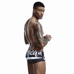 a hot gay man in black Alphabet Splash Square Cut Swim Trunks - pridevoyageshop.com - gay men’s underwear and swimwear