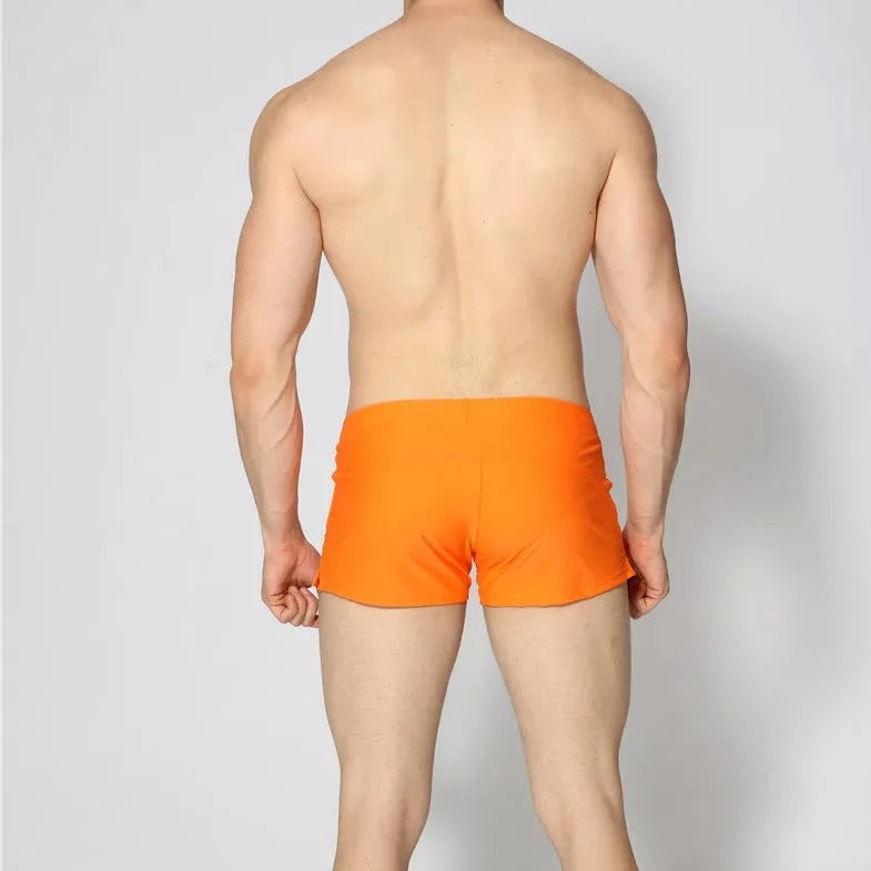 a hot gay man in orange Solid Color Pocketed Swim Trunks - pridevoyageshop.com - gay men’s underwear and swimwear