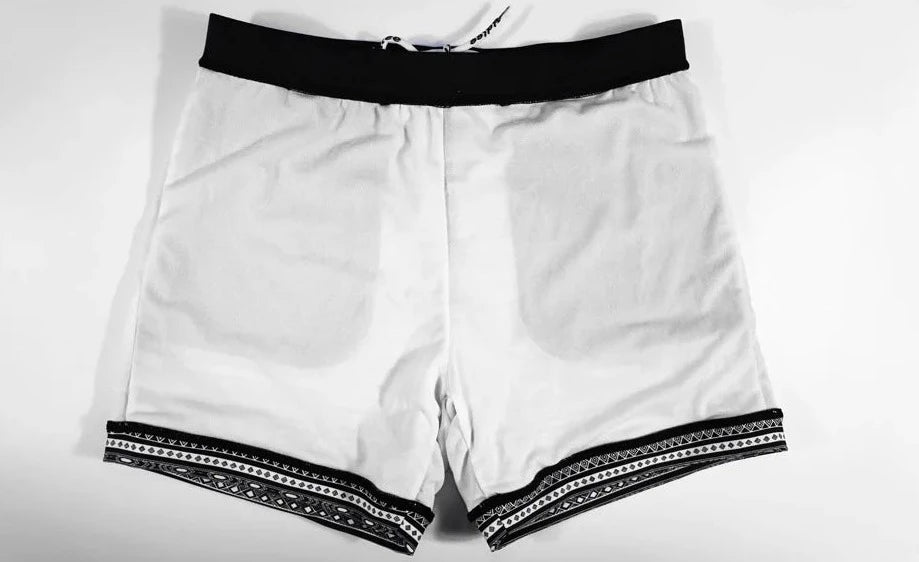 details of a hot man in Aztec Tribal Tight Board Shorts - pridevoyageshop.com - gay men’s underwear and swimwear