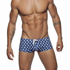 a hot gay man in blue Stars Tight Square Cut Swim Trunks - pridevoyageshop.com - gay men’s underwear and swimwear