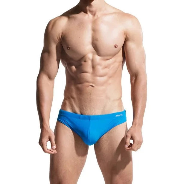 a sexy gay man in blue DESMIIT Solid Color Swim Briefs - pridevoyageshop.com - gay men’s underwear and swimwear