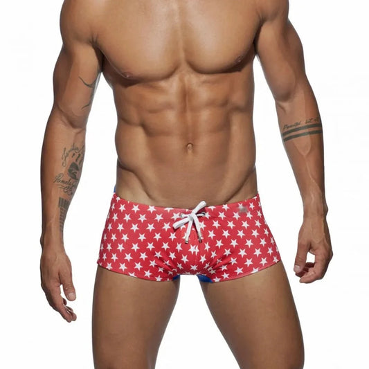 a hot gay man in red Stars Tight Square Cut Swim Trunks - pridevoyageshop.com - gay men’s underwear and swimwear