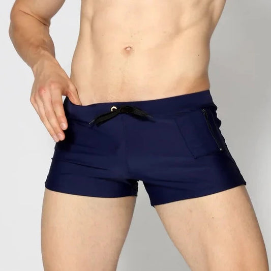 a hot gay man in navy Solid Color Pocketed Swim Trunks - pridevoyageshop.com - gay men’s underwear and swimwear