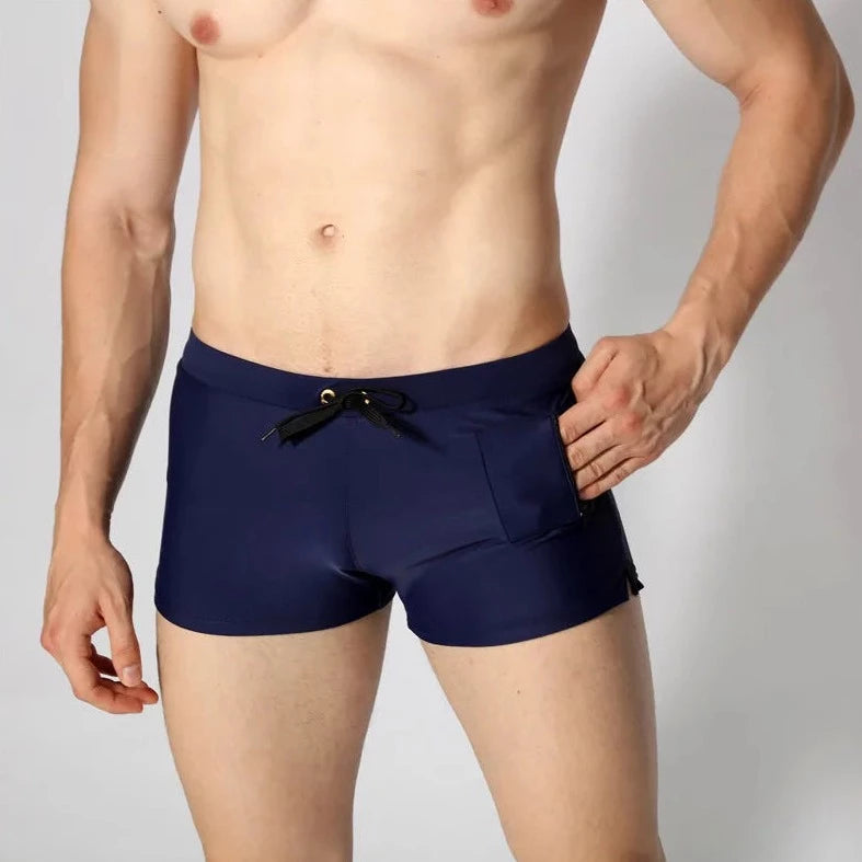 a hot gay man in navy Solid Color Pocketed Swim Trunks - pridevoyageshop.com - gay men’s underwear and swimwear