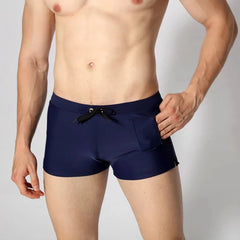 a hot gay man in navy Solid Color Pocketed Swim Trunks - pridevoyageshop.com - gay men’s underwear and swimwear