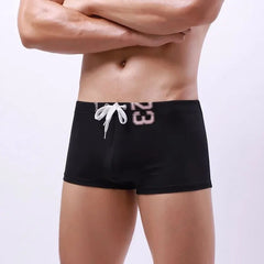 a hot gay man in black Men's 23 Bowtie Swim Trunks - pridevoyageshop.com - gay men’s underwear and swimwear