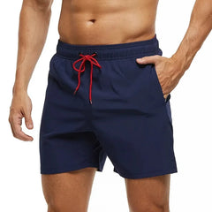 a hot gay man in navy blue Solid Color Pocketed Board Shorts - pridevoyageshop.com - gay men’s underwear and swimwear