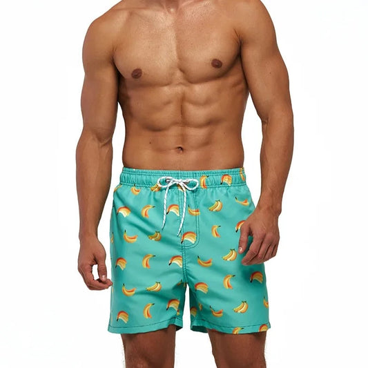 a hot gay man in Falling Bananas Board Shorts - pridevoyageshop.com - gay men’s underwear and swimwear