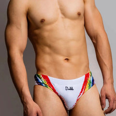 a sexy gay man in white DM Rainbow Splash Swim Briefs - pridevoyageshop.com - gay men’s underwear and swimwear