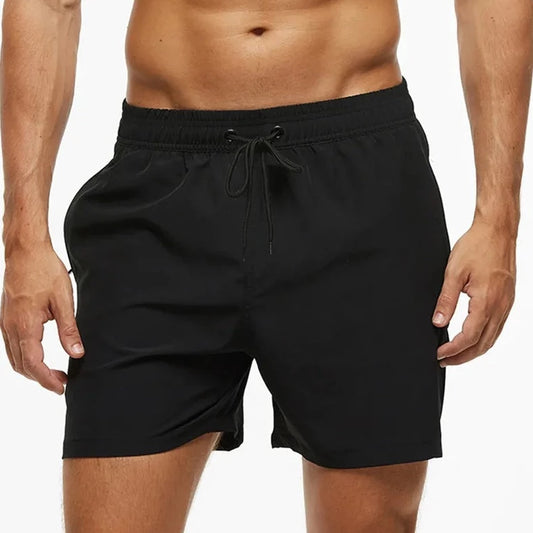 a hot gay man in black Solid Color Pocketed Board Shorts - pridevoyageshop.com - gay men’s underwear and swimwear