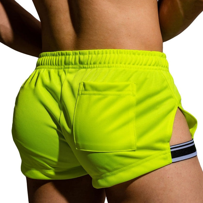 sexy gay man in Fluorescent Green Gay Shorts | DM Side Show Gym Shorts - Men's Activewear, gym short, sport shorts, running shorts- pridevoyageshop.com