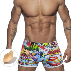 a hot gay man in Pop Art Plunge Swim Trunks - pridevoyageshop.com - gay men’s underwear and swimwear