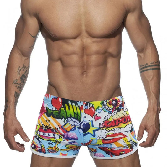 a hot gay man in Pop Art Plunge Swim Trunks - pridevoyageshop.com - gay men’s underwear and swimwear