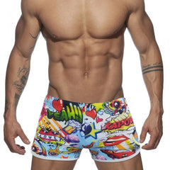 a hot gay man in Pop Art Plunge Swim Trunks - pridevoyageshop.com - gay men’s underwear and swimwear