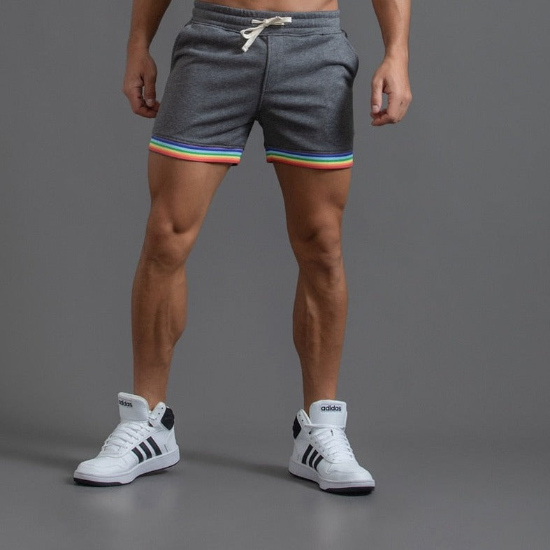 sexy gay man in dark gray Men's Rainbow Gym Shorts with Pockets | Gay Shorts - Men's Activewear, gym short, sport shorts, running shorts- pridevoyageshop.com