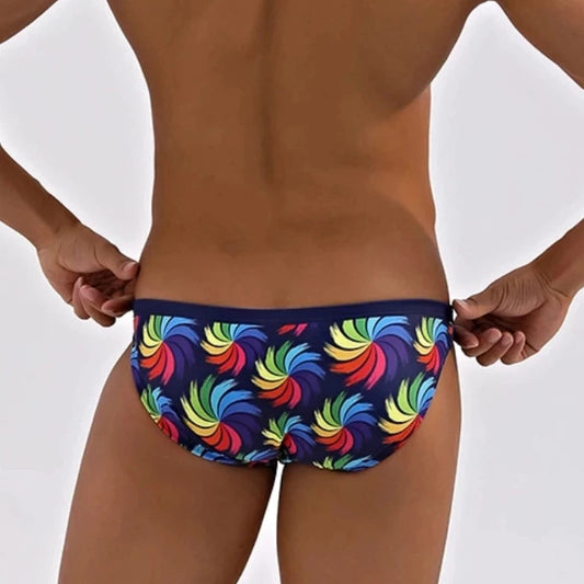 a hot gay man in Rainbow Whirlpool Skinny Swim Briefs - pridevoyageshop.com - gay men’s underwear and swimwear