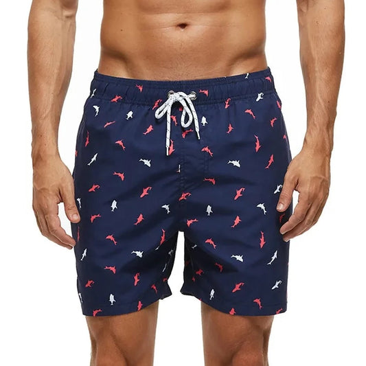 a hot gay man in Little Red + White Fish Board Shorts - pridevoyageshop.com - gay men’s underwear and swimwear