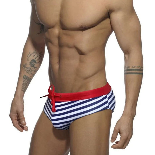 a hot gay man in blue Sailor‘s Striped Bowtie Swim Briefs - pridevoyageshop.com - gay men’s underwear and swimwear