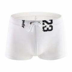 white Men's 23 Bowtie Swim Trunks - pridevoyageshop.com - gay men’s underwear and swimwear