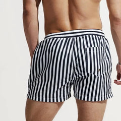a hot gay man in striped Desmiit Vertical Striped Board Shorts - pridevoyageshop.com - gay men’s underwear and swimwear