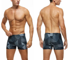 a hot gay man in Men's Gray Geo Swim Trunks - pridevoyageshop.com - gay men’s underwear and swimwear