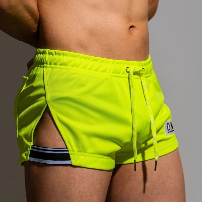 sexy gay man in Fluorescent Green Gay Shorts | DM Side Show Gym Shorts - Men's Activewear, gym short, sport shorts, running shorts- pridevoyageshop.com