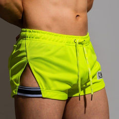 sexy gay man in Fluorescent Green Gay Shorts | DM Side Show Gym Shorts - Men's Activewear, gym short, sport shorts, running shorts- pridevoyageshop.com