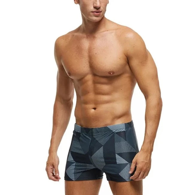 a hot gay man in Men's Gray Geo Swim Trunks - pridevoyageshop.com - gay men’s underwear and swimwear