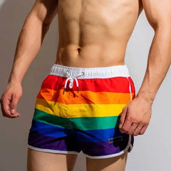 a hot gay man in DM Rainbow Swim Trunks - pridevoyageshop.com - gay men’s underwear and swimwear