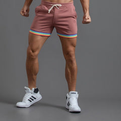 sexy gay man in Brick red Men's Rainbow Gym Shorts with Pockets | Gay Shorts - Men's Activewear, gym short, sport shorts, running shorts- pridevoyageshop.com