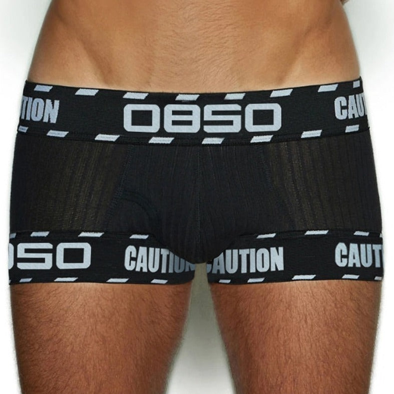 front of a man in Black OBSO Men's Low Rise Boxer Briefs Underwear - pridevoyageshop.com - gay men’s underwear and swimwear