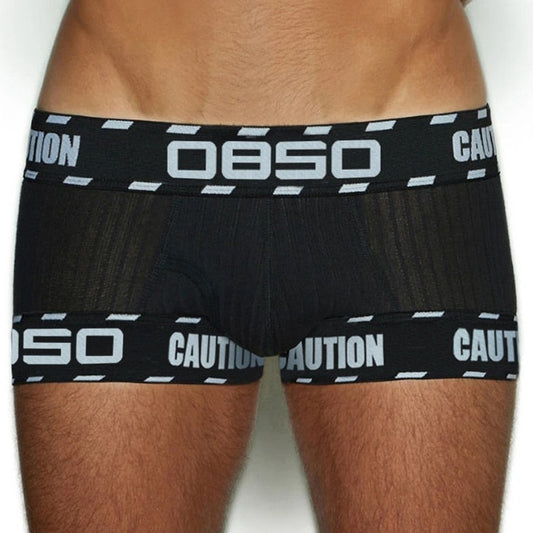 front of a man in Black OBSO Men's Low Rise Boxer Briefs Underwear - pridevoyageshop.com - gay men’s underwear and swimwear