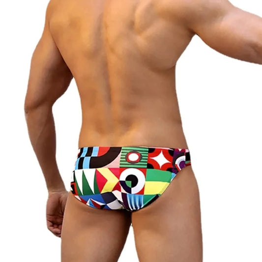 a sexy gay man in Colorful Patchwork Swim Briefs - pridevoyageshop.com - gay men’s underwear and swimwear