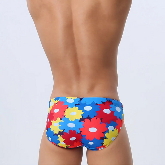 a sexy man in Men’s Bloom & Bust Swim Briefs - pridevoyageshop.com - gay men’s sexy swim briefs, trunks, board shorts, and bikinis
