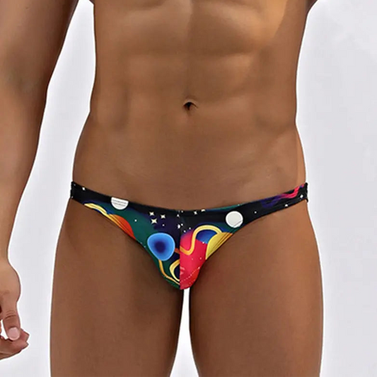 a sexy man in Men’s Orbit My Ass Bikini Swim Briefs - pridevoyageshop.com - gay men’s sexy swim briefs, trunks, board shorts, and bikinis