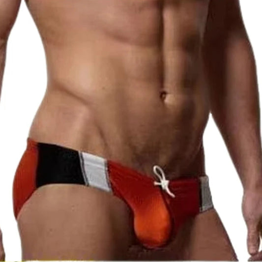 a sexy man in Men’s Red Rocket Pouch Swim Briefs - pridevoyageshop.com - gay men’s sexy swim briefs, trunks, board shorts, and bikinis