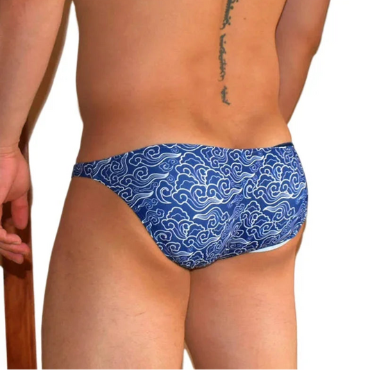 a sexy man in Men’s Ride the Wave Bikini Swim Briefs - pridevoyageshop.com - gay men’s sexy swim briefs, trunks, board shorts, and bikinis