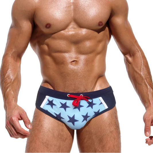 a sexy man in Men’s Star-Spangled Swim Briefs - pridevoyageshop.com - gay men’s sexy swim briefs, trunks, board shorts, and bikinis