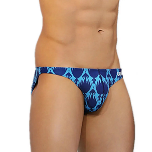 a sexy man in Men’s Tropical Blue Inferno Swim Briefs - pridevoyageshop.com - gay men’s sexy swim briefs, trunks, board shorts, and bikinis
