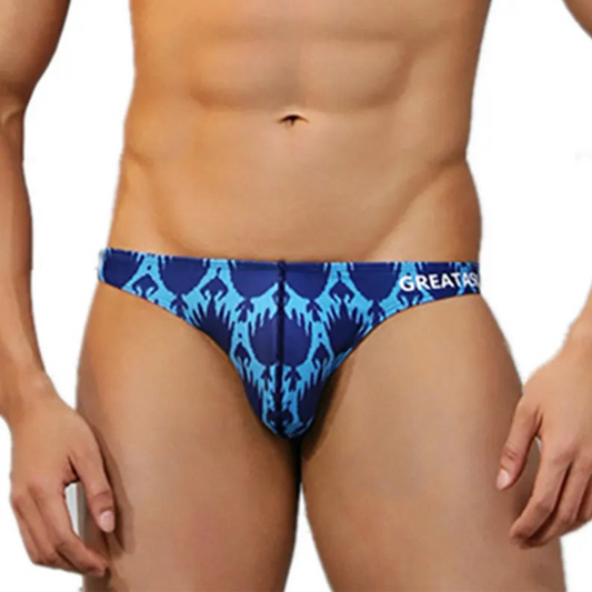 a sexy man in Men’s Tropical Blue Inferno Swim Briefs - pridevoyageshop.com - gay men’s sexy swim briefs, trunks, board shorts, and bikinis
