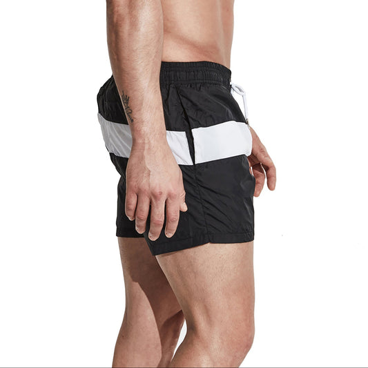 a sexy man in black Men’s Block Party Volley Swim Short – pridevoyageshop.com – gay men’s sexy swim briefs, trunks, board shorts, and bikinis