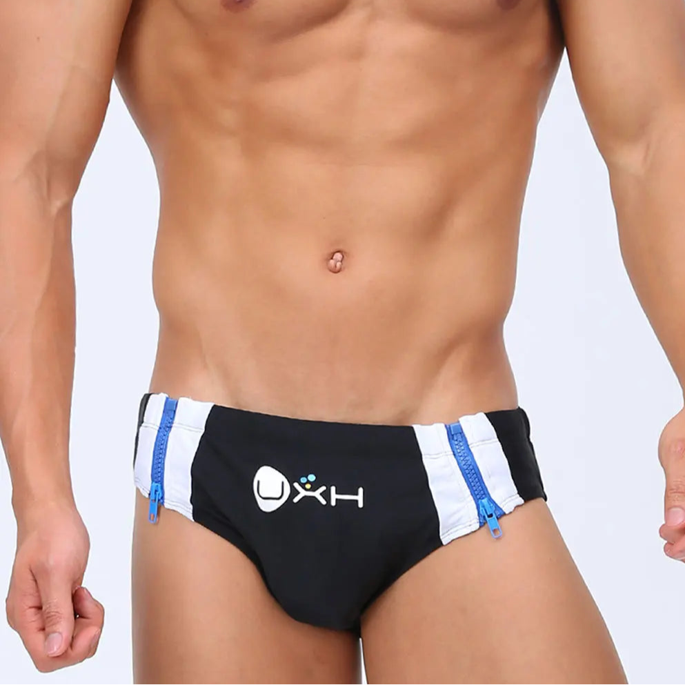 a sexy man in black Men’s Double Zipper Pouch Swim Briefs - pridevoyageshop.com - gay men’s sexy swim briefs, trunks, board shorts, and bikinis