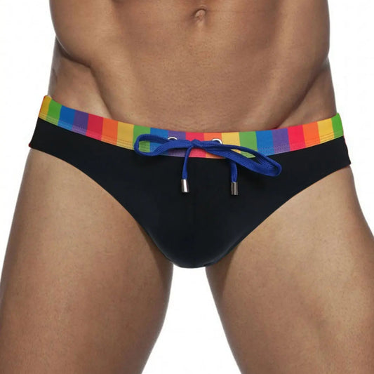 a sexy man in black Men’s Pride Patrol Rainbow Band Swim Briefs - pridevoyageshop.com - gay men’s sexy swim briefs, trunks, board shorts, and bikinis