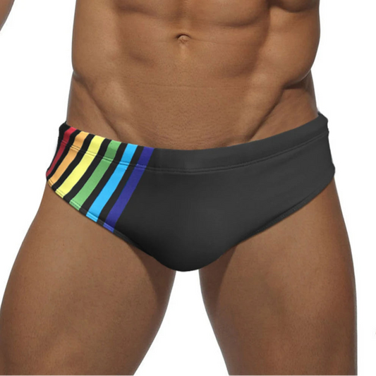 a sexy man in black Men’s Pride Streak Bikini Swim Briefs - pridevoyageshop.com - gay men’s sexy swim briefs, trunks, board shorts, and bikinis